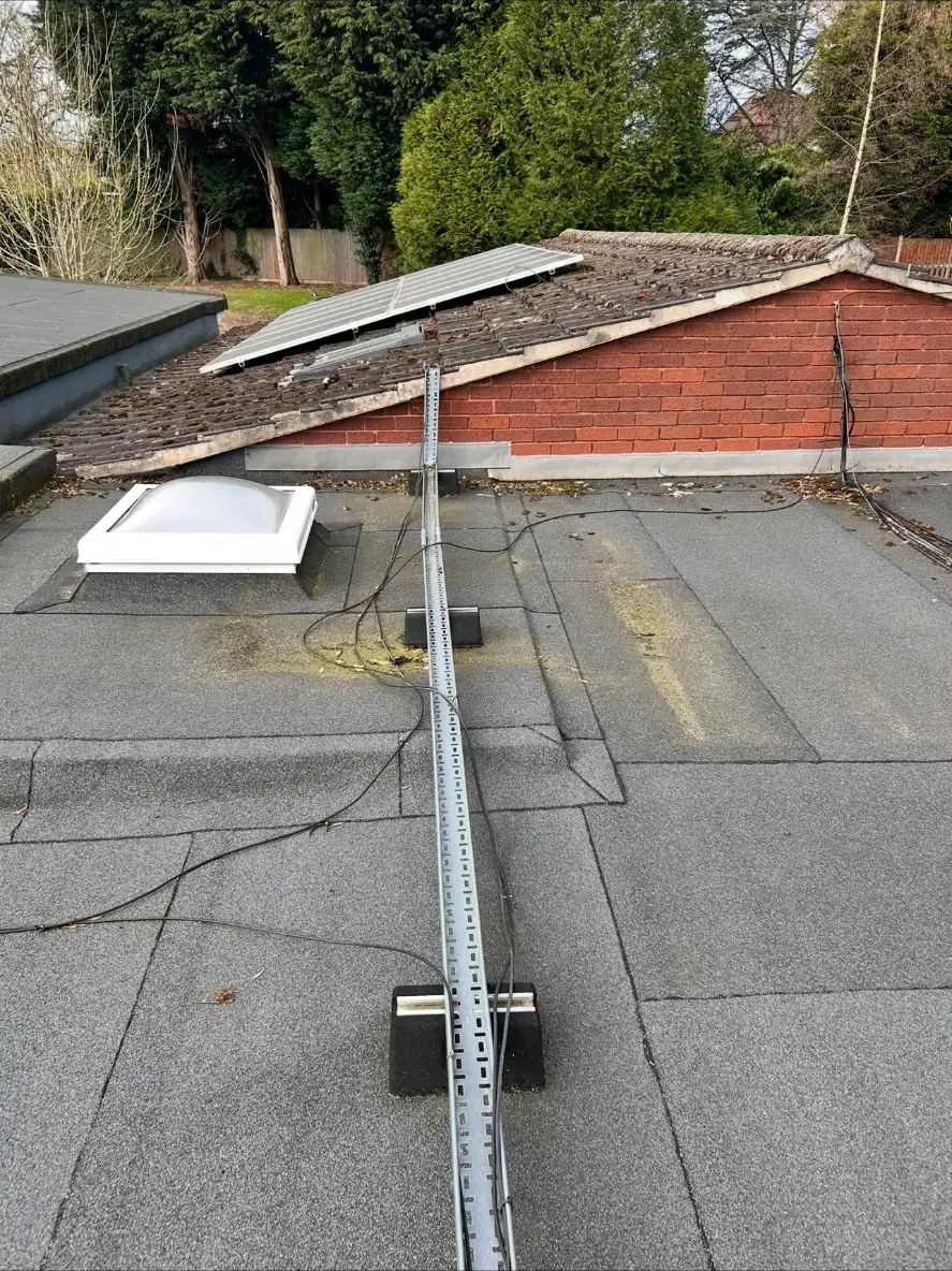 Cable runs and cable tray across the school flat roof during inspection