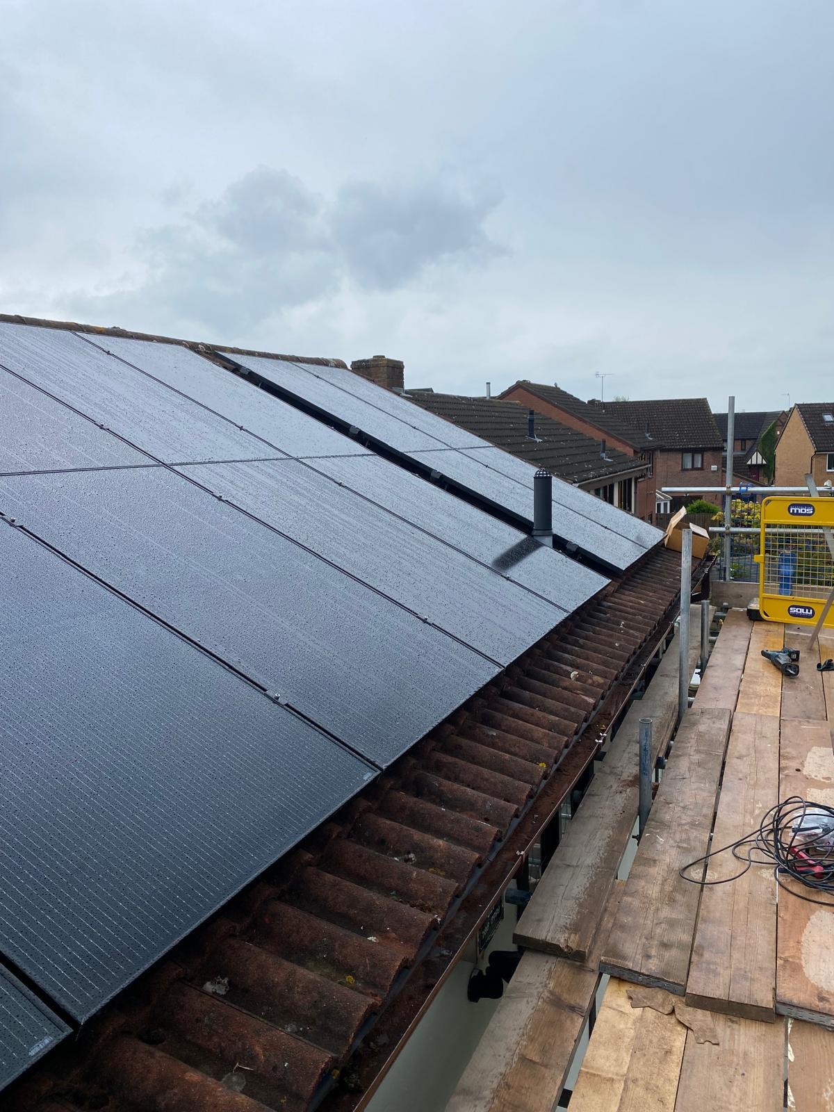 Solar panels fitted across a pitched residential roof during installation