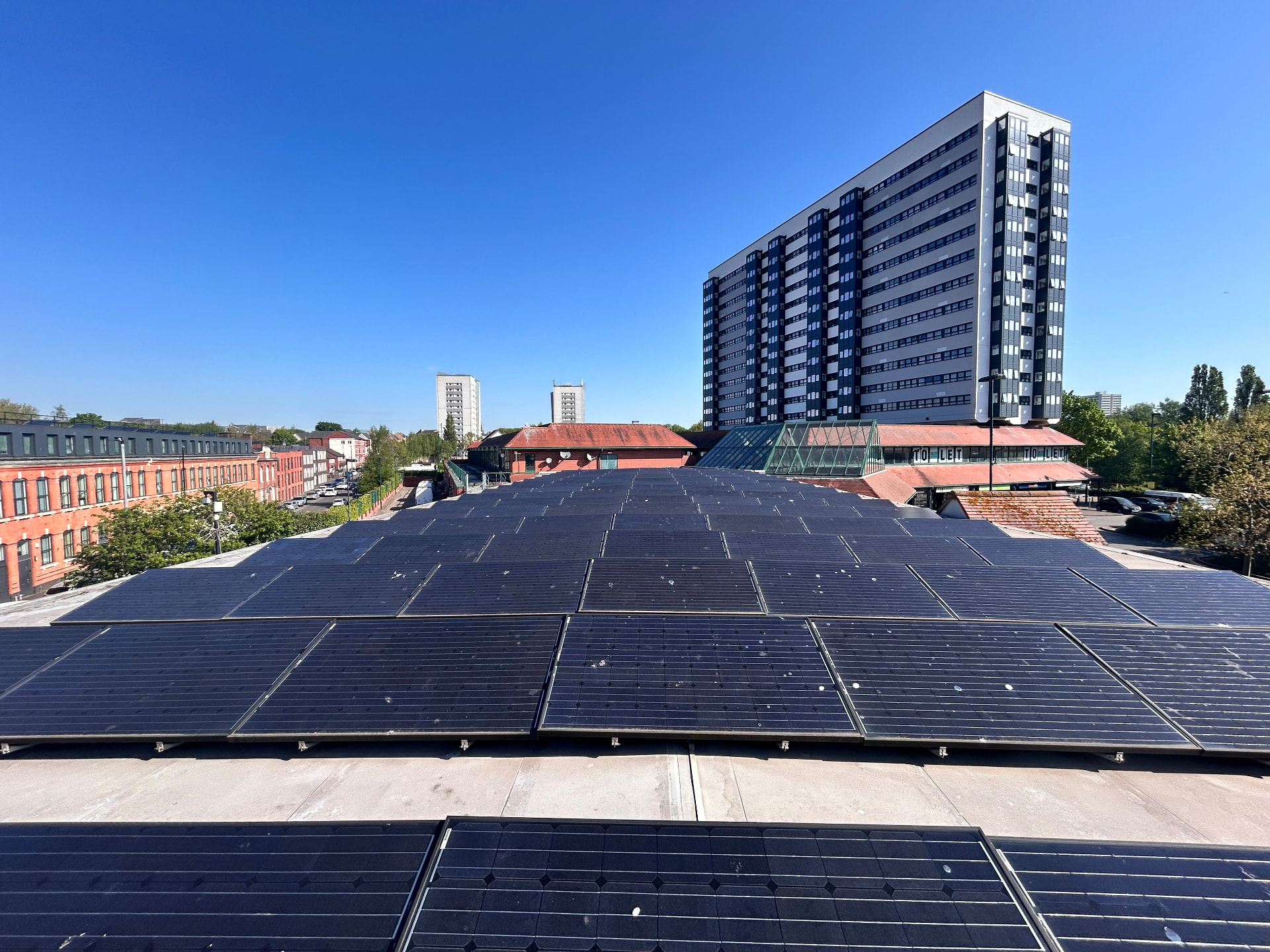 Flat-roof solar array inspected by Solar Pro Solutions in an urban setting