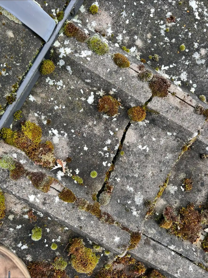 A cracked roof tile beside the solar mounting system