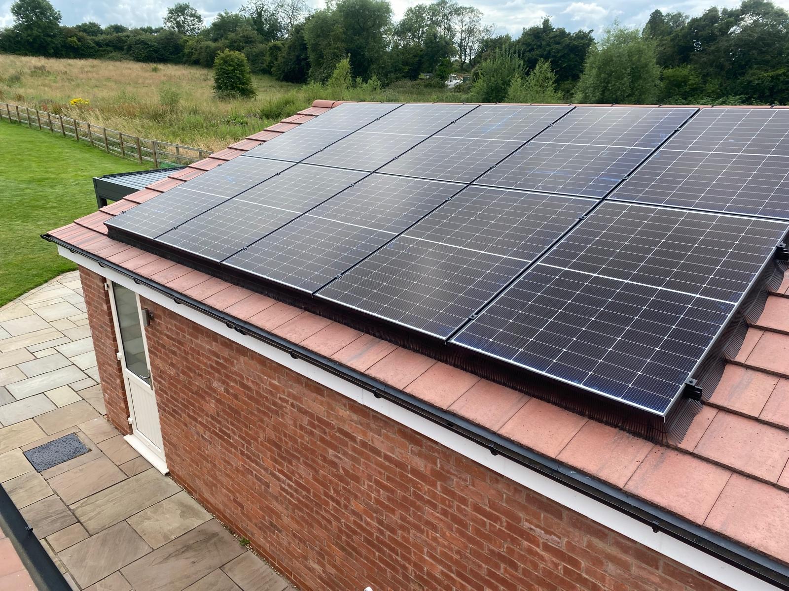 All-black solar array installed on a red-brick UK property